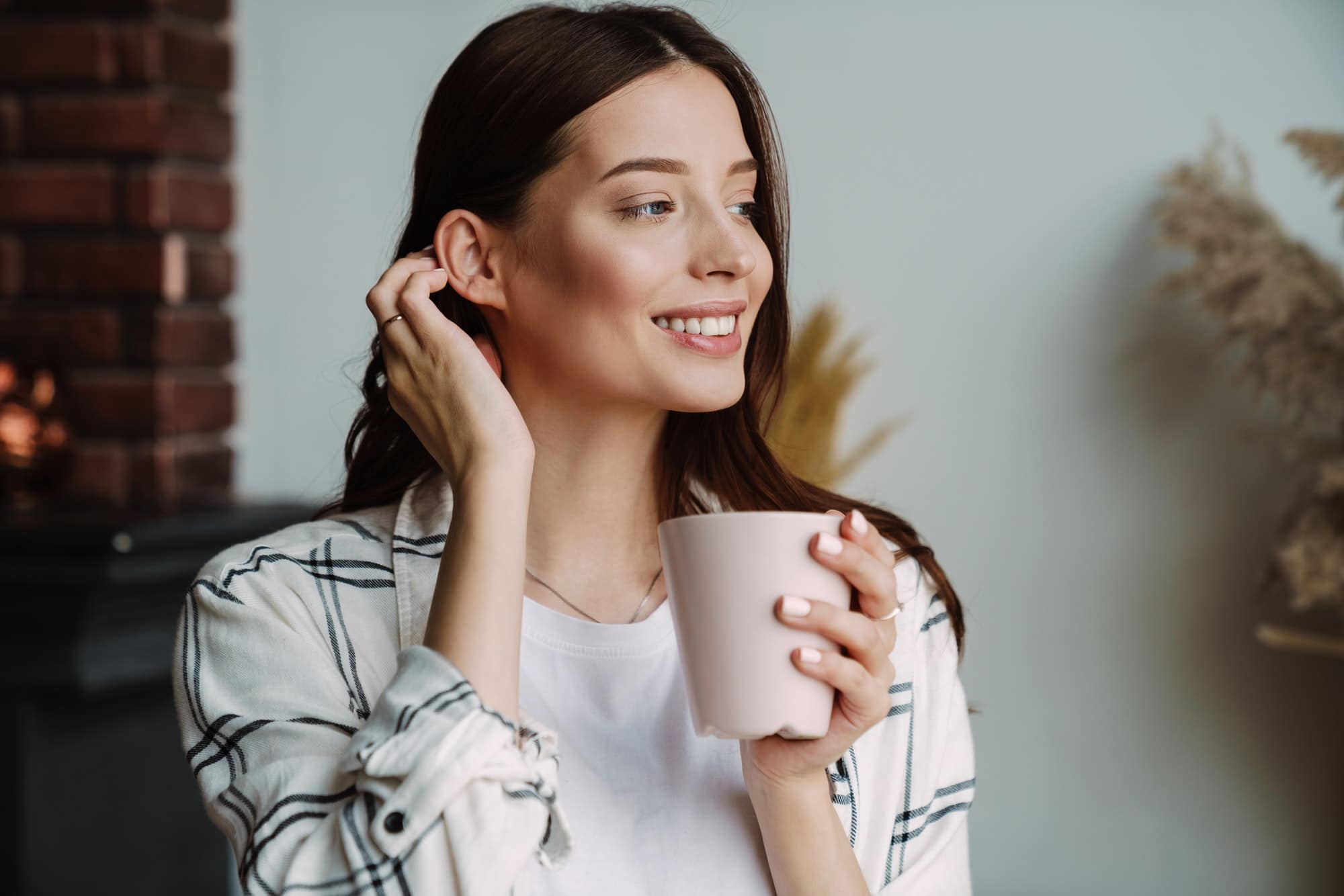 Beautiful happy nice woman smiling and drinking coffee