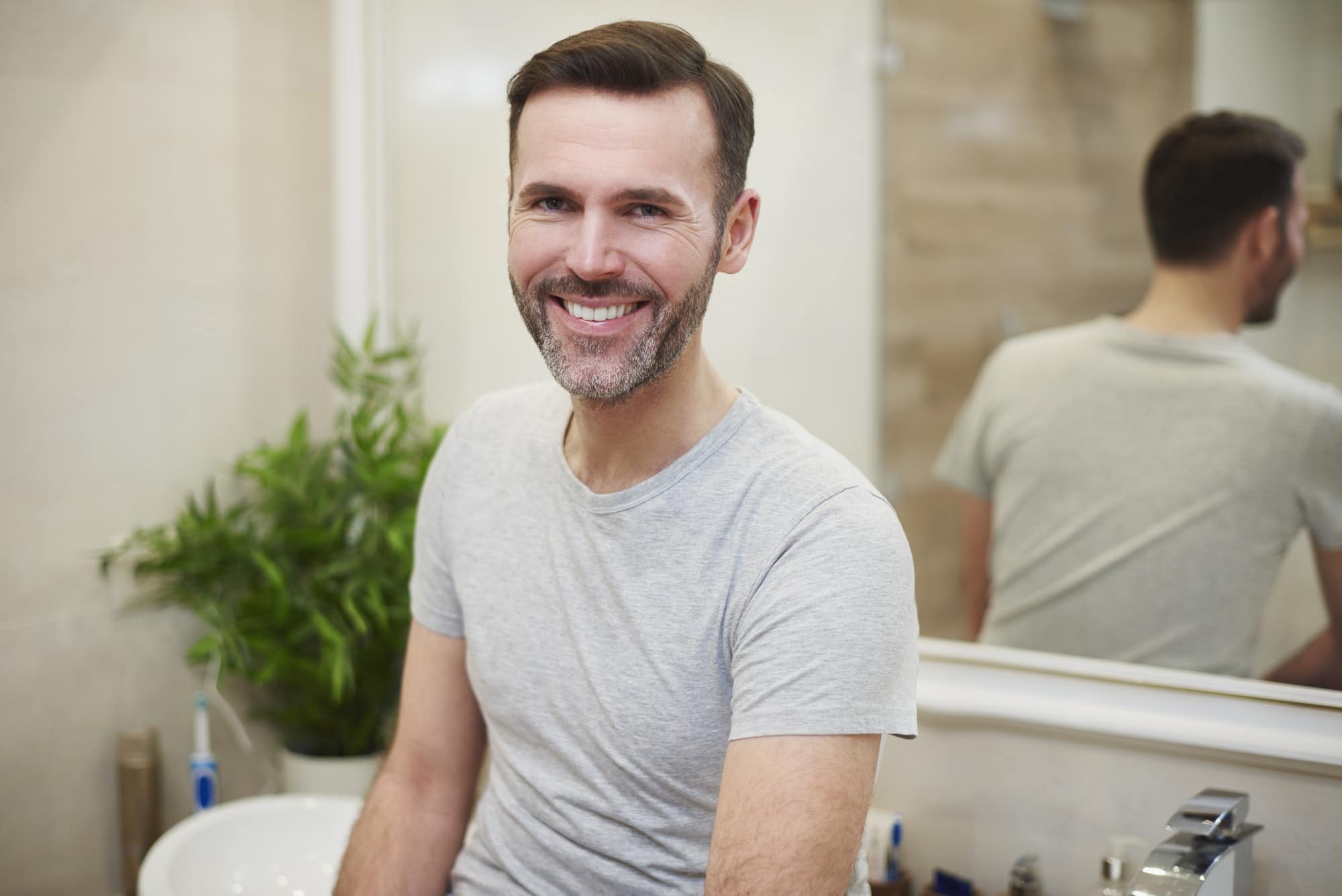 Portrait of smiling man in the bathroom