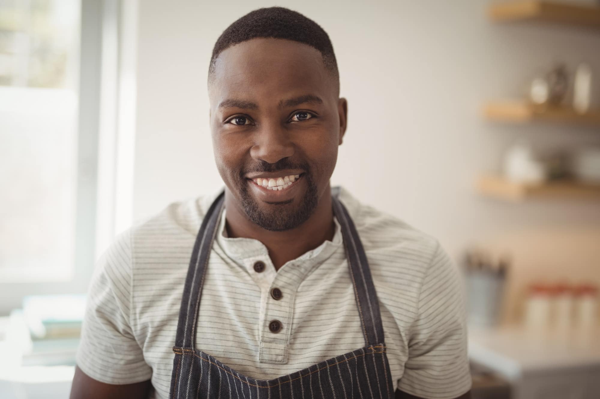 Smiling man standing in kitchen